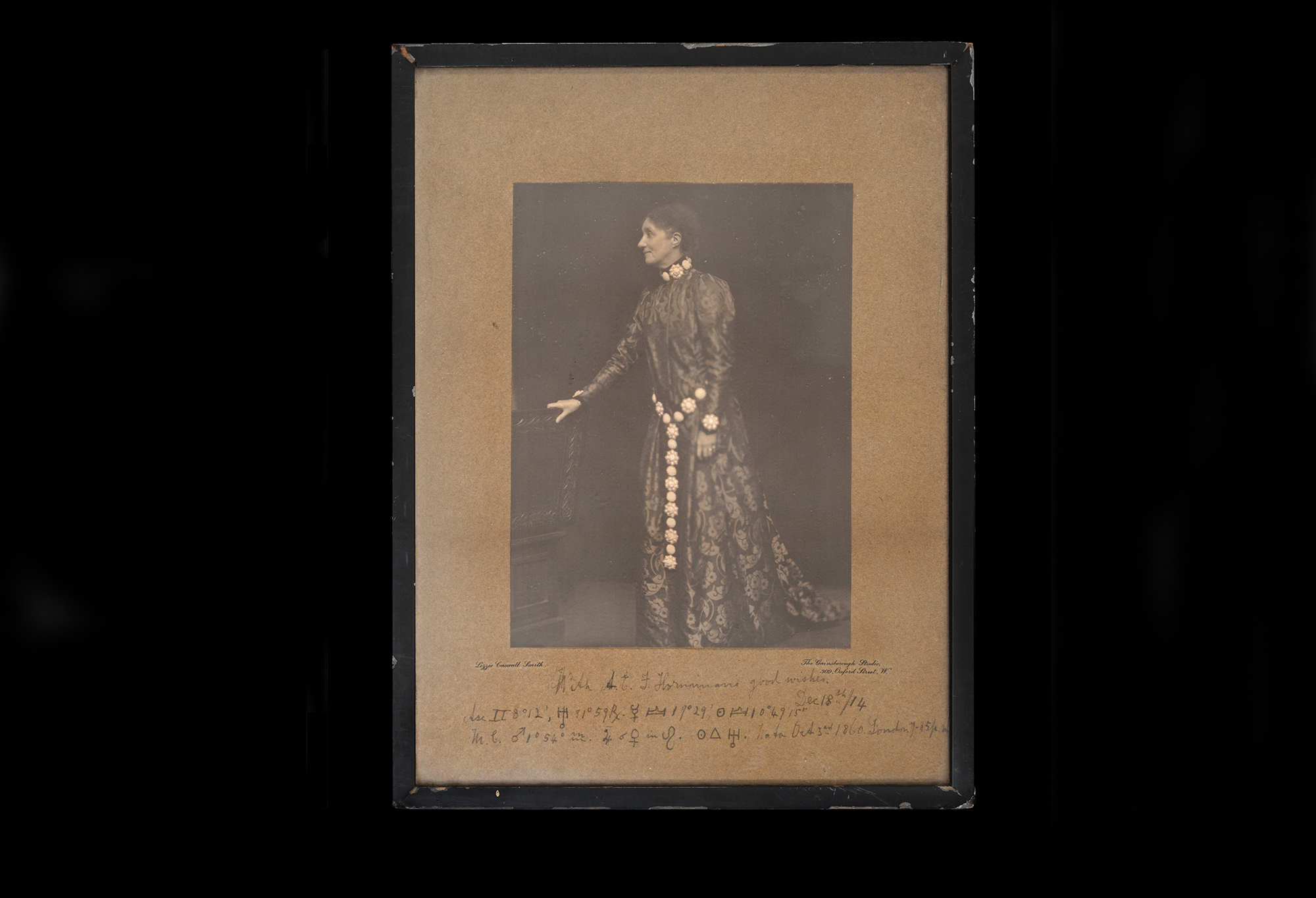 Woman in period dress with Long chain around hip.