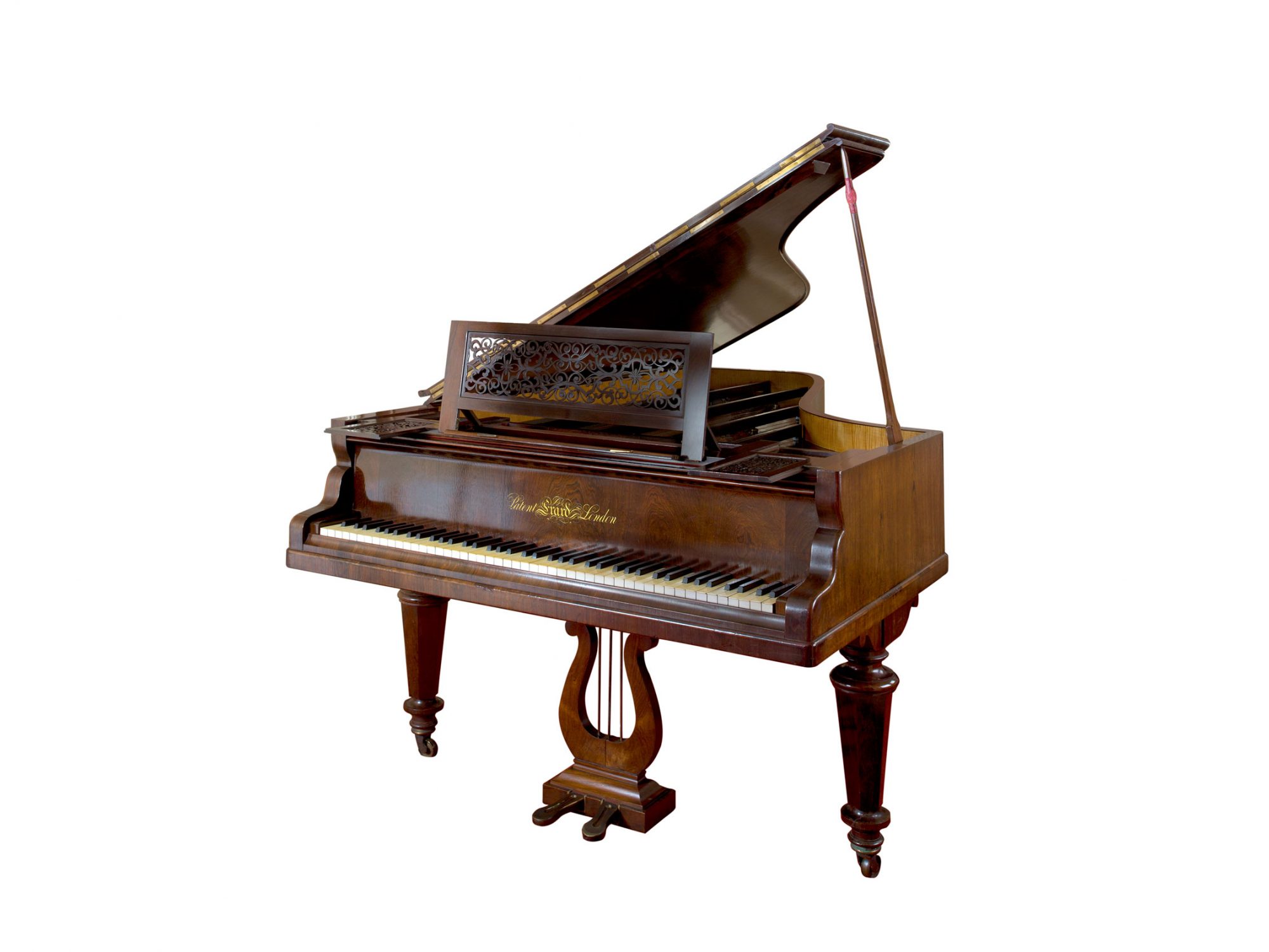 A wooden piano with an open top, and the keyboard lid open.