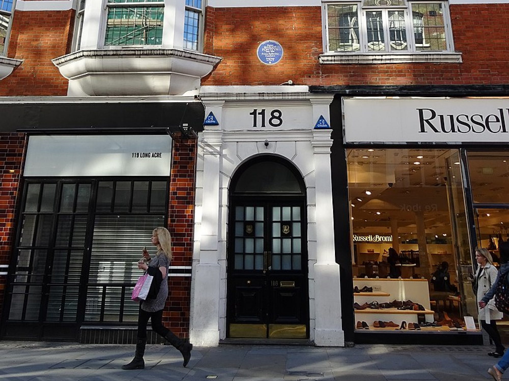 A shot of a door and some flats above in London. The building looks a couple of hundred years old