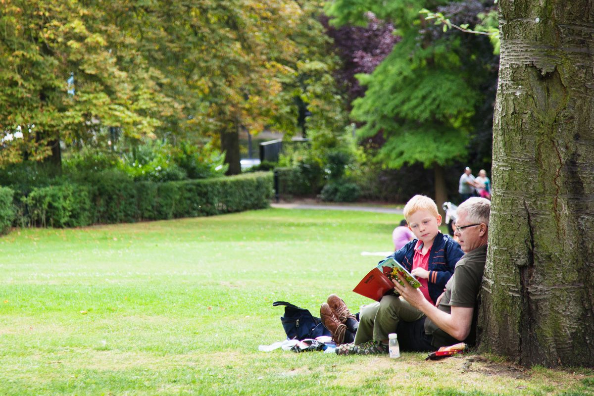 A family reading in the Gardens