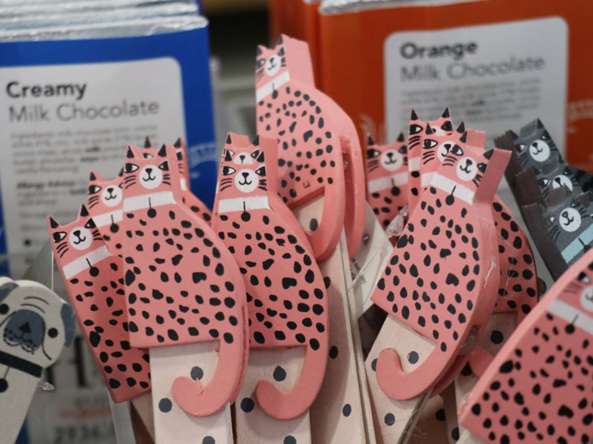 A bunch of wooden bookmarks with ginger spotted cats on the top in a clear holder
