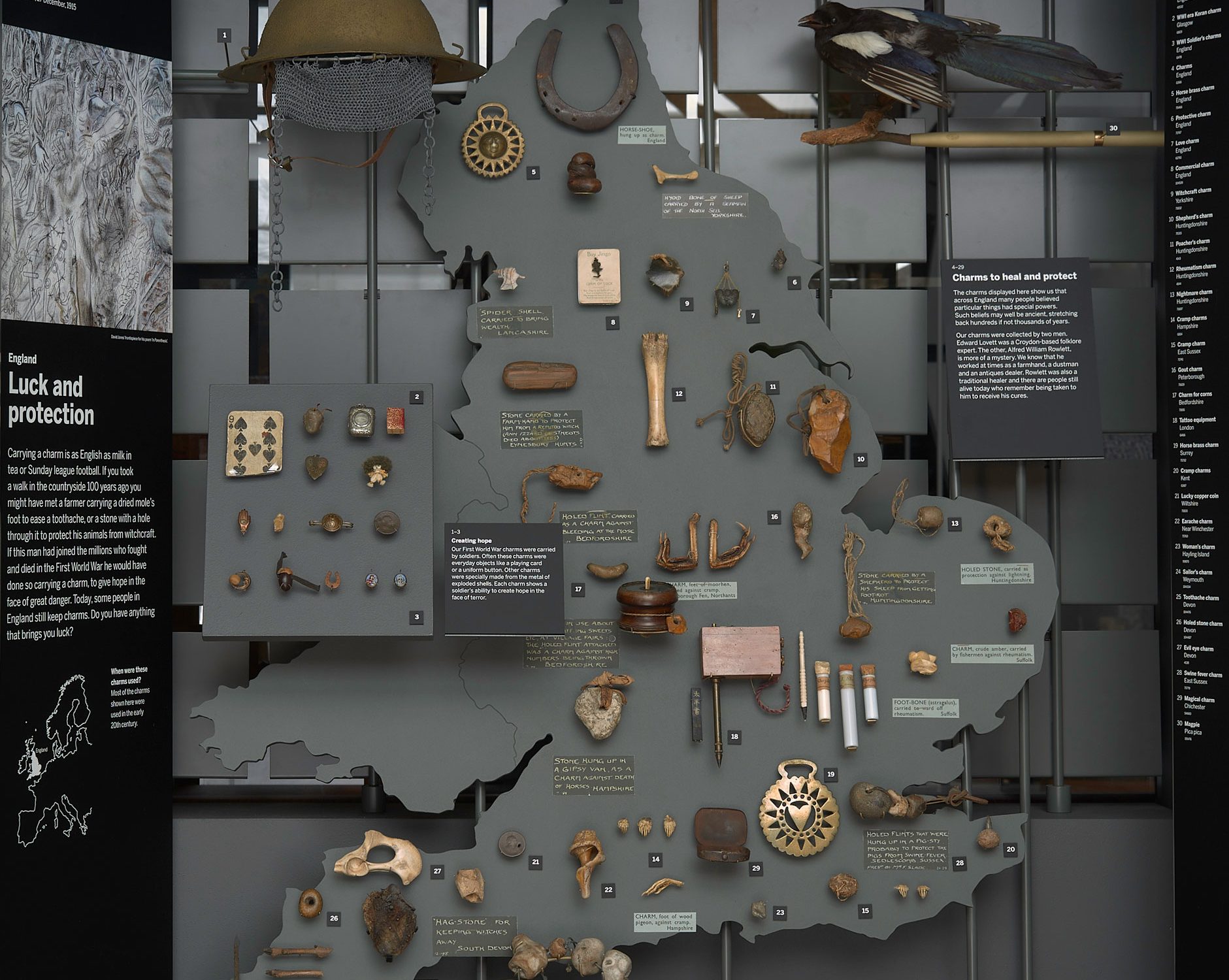 A board cut into the shape of England and Wales, with charms positioned across it correlating to near where they were sourced from, including moles feet, shells, stones and bones.
