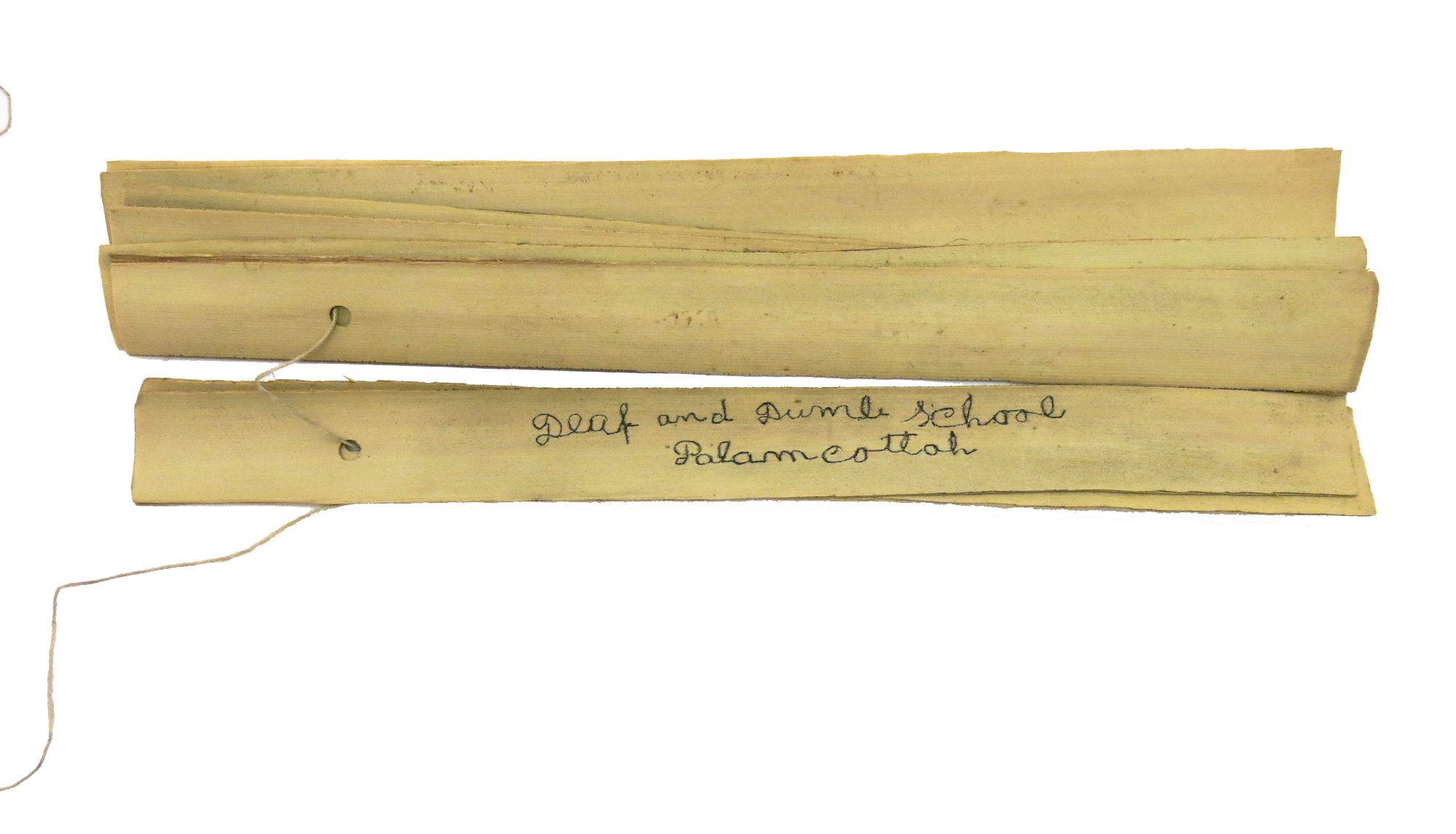 Manuscript of eight palm leaf sections, nearly all in Tamil, but one leaf is inscribed 'Deaf and Dumb School, Palamcottah'. Inscribed on one side only, apart from one which is inscribed on both sides.The palm leaf sections are joined by a fine string passing through a hole at one end of each.