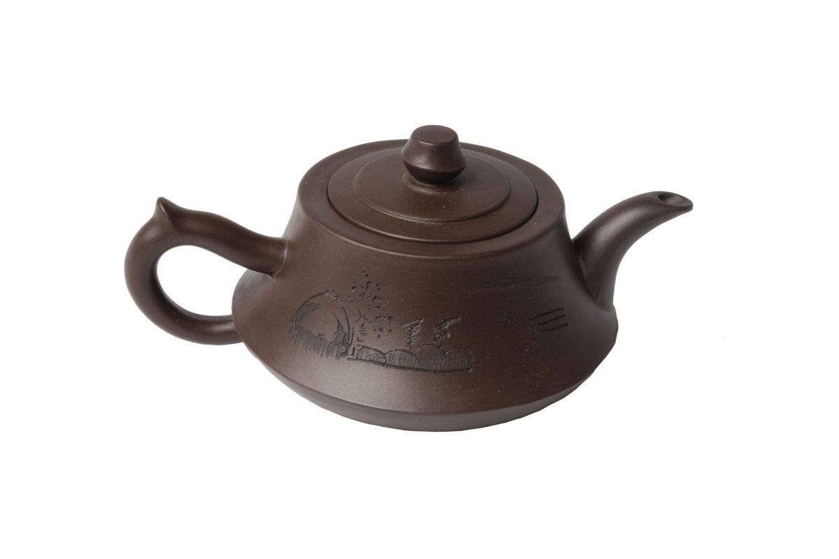 A round brown pottery tea pot with a handle, lid and spout