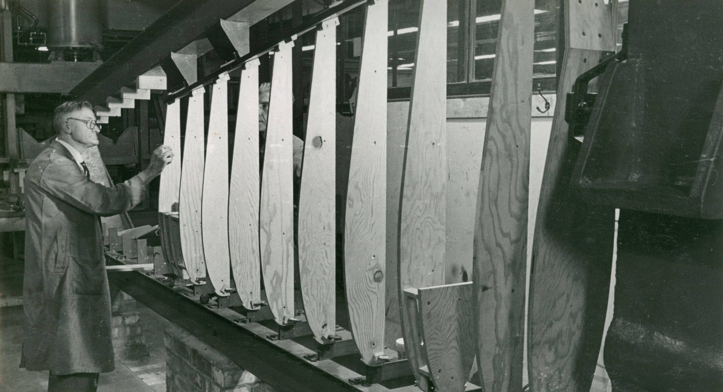 Man standing by wooden panels