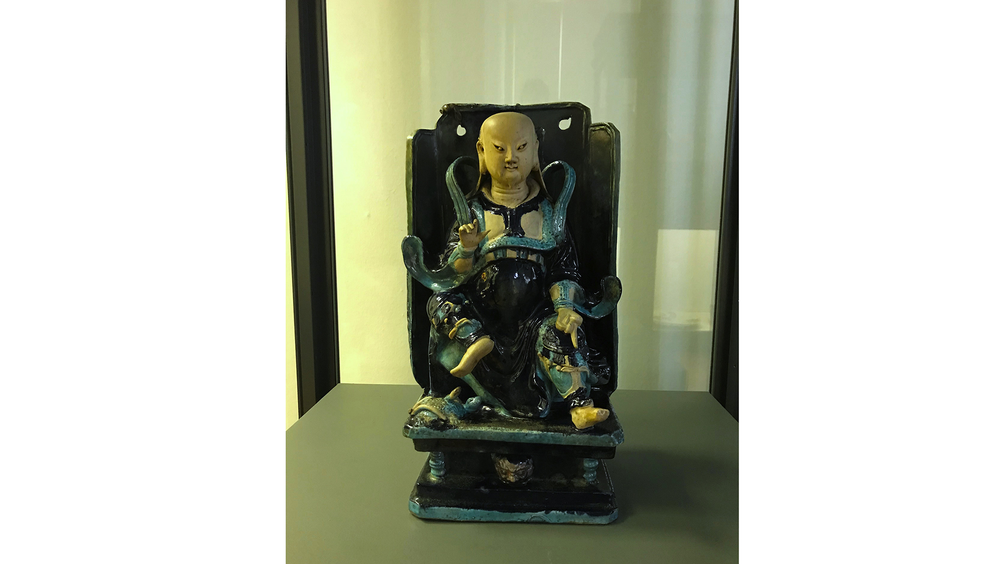 Figure of man sitting in chair