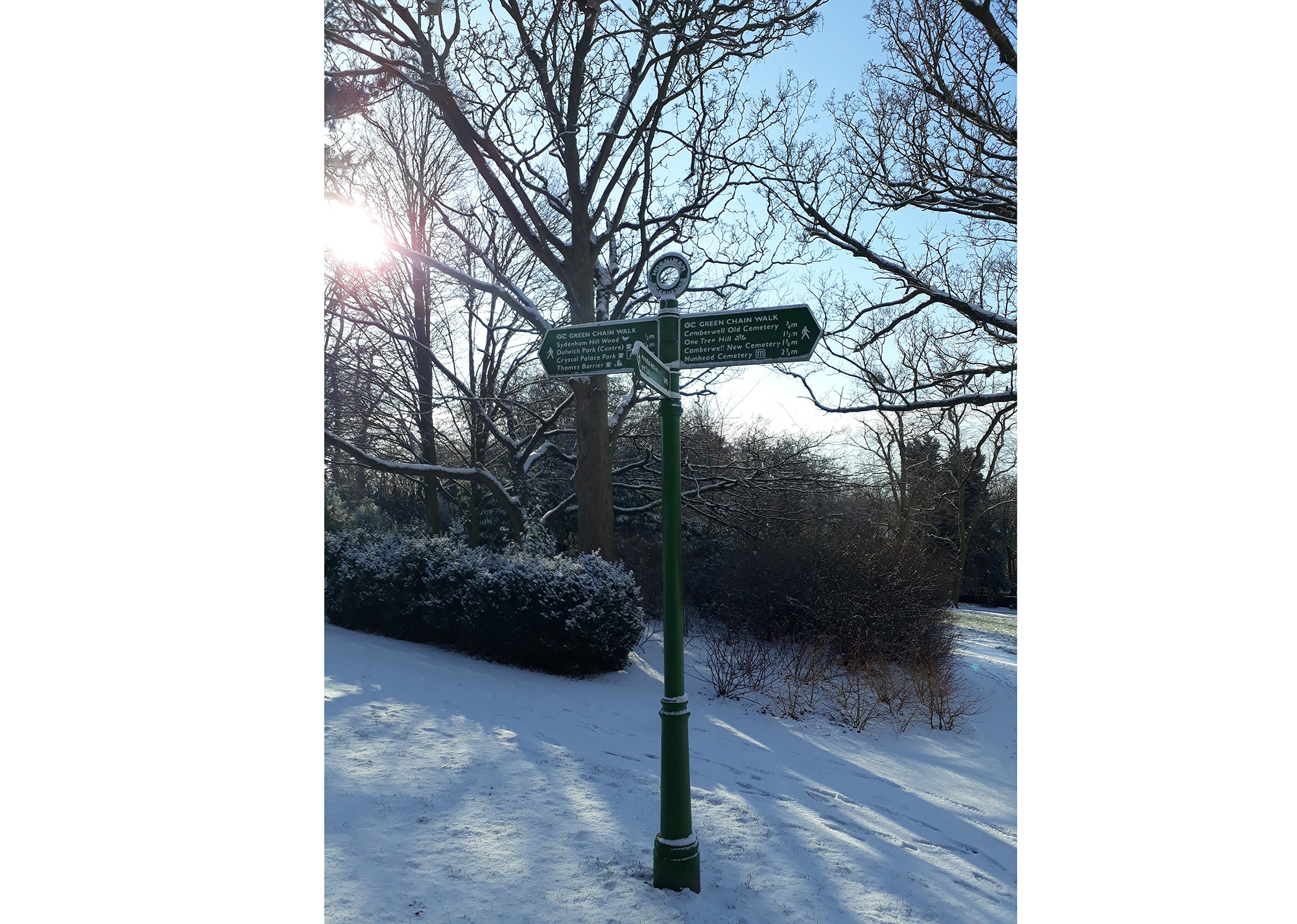 Sign post in Gardens on snowy day