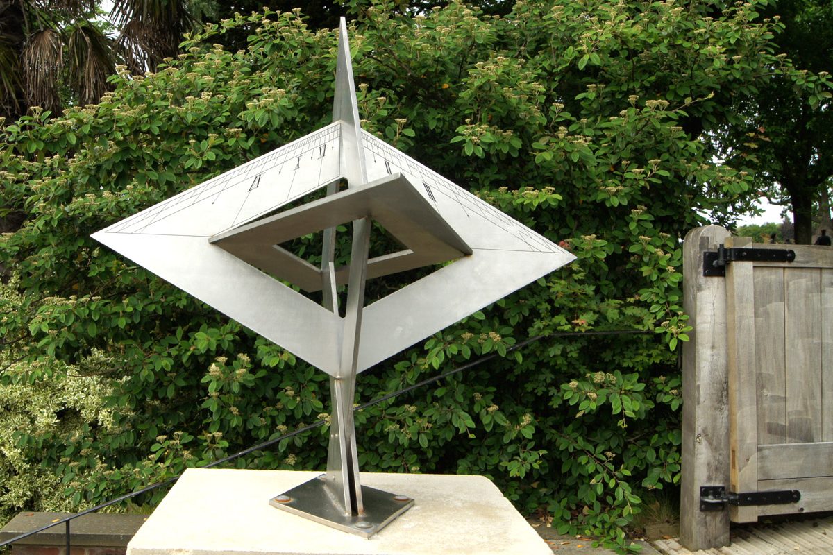 A metal angular sundial in a garden