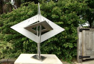 A metal angular sundial in a garden