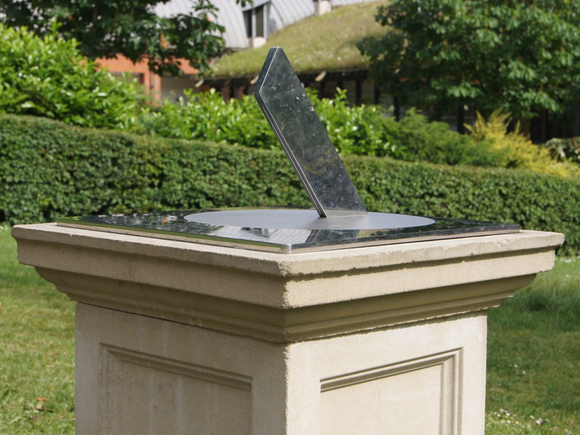 A metal sundial in a garden