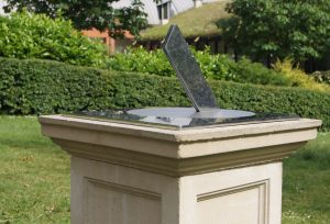 A metal sundial in a garden