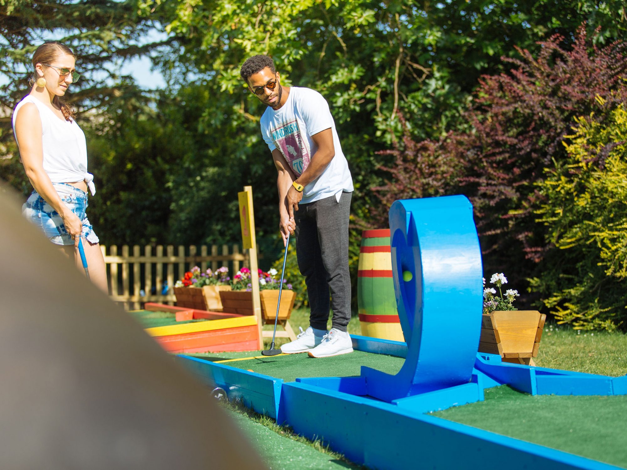 A young man trying a looping hole in golf