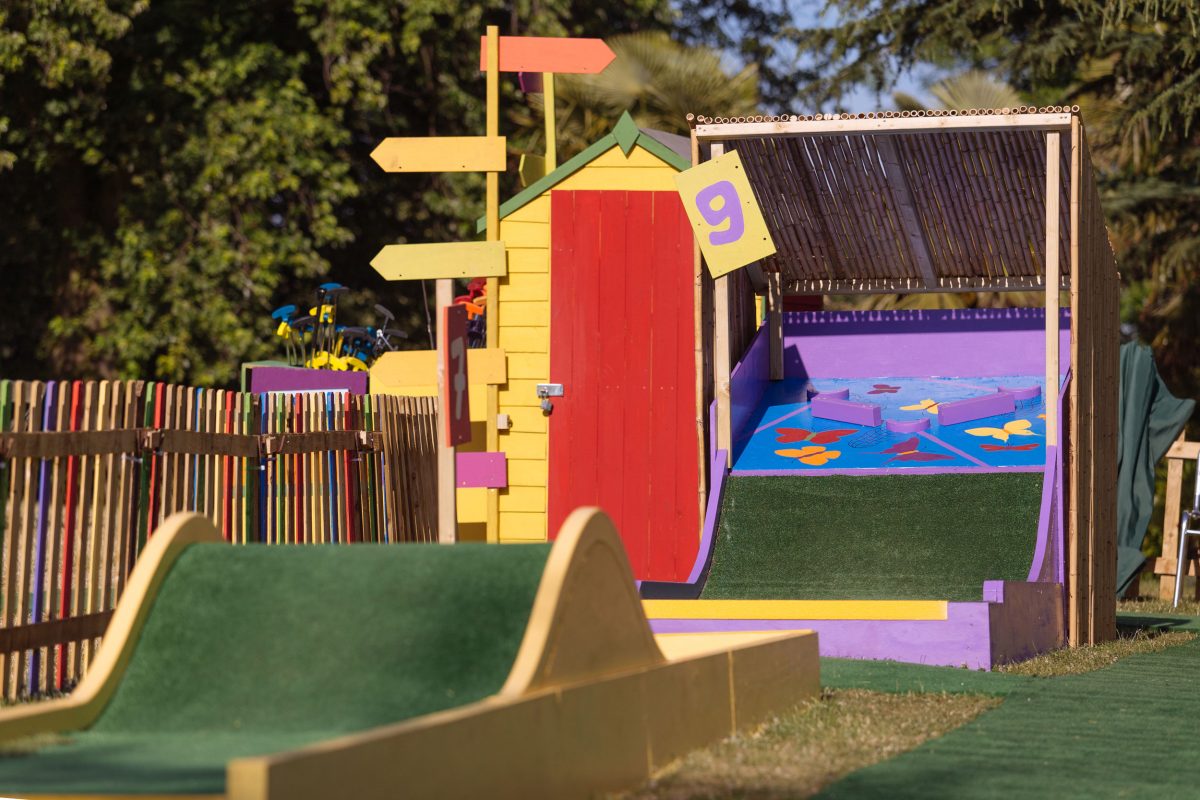 Part of a crazy golf course with wooden and astroturf holes
