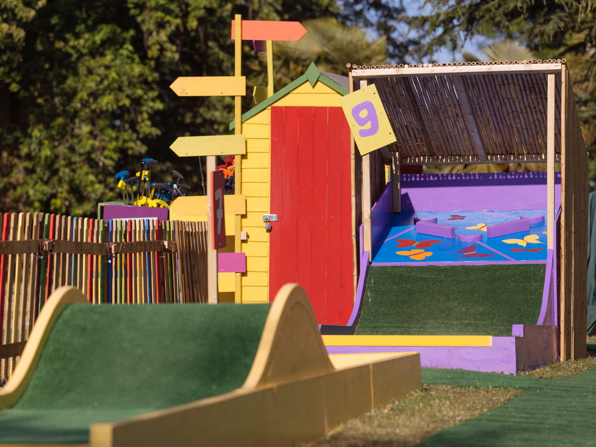 Part of a crazy golf course with wooden and astroturf holes