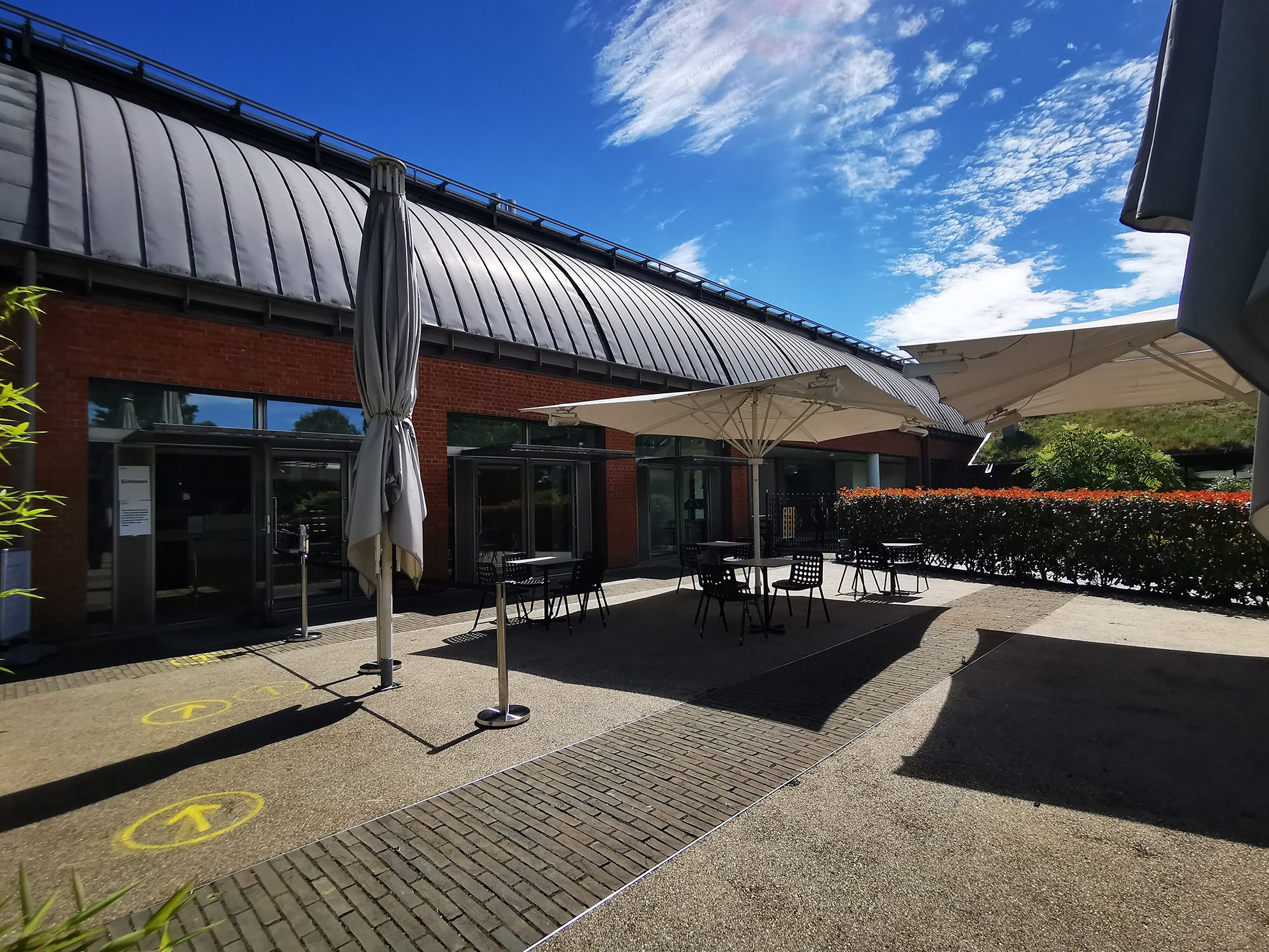 Open terrace with seating and parasols. Clear skies.