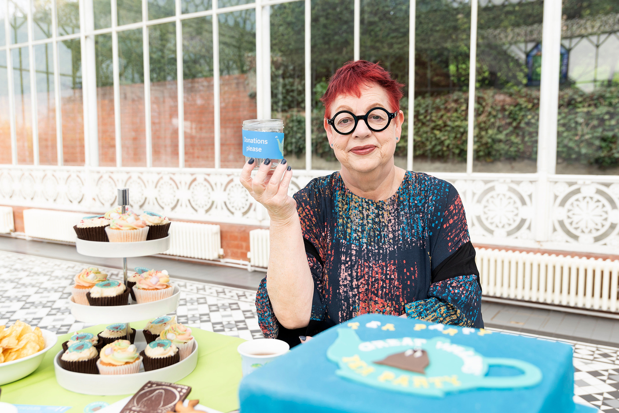 Woman sat at table with a variety of cake