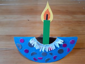 Paper decoration shaped like a lit candle.