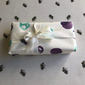 Present wrapped with spotted paper and white ribbon 