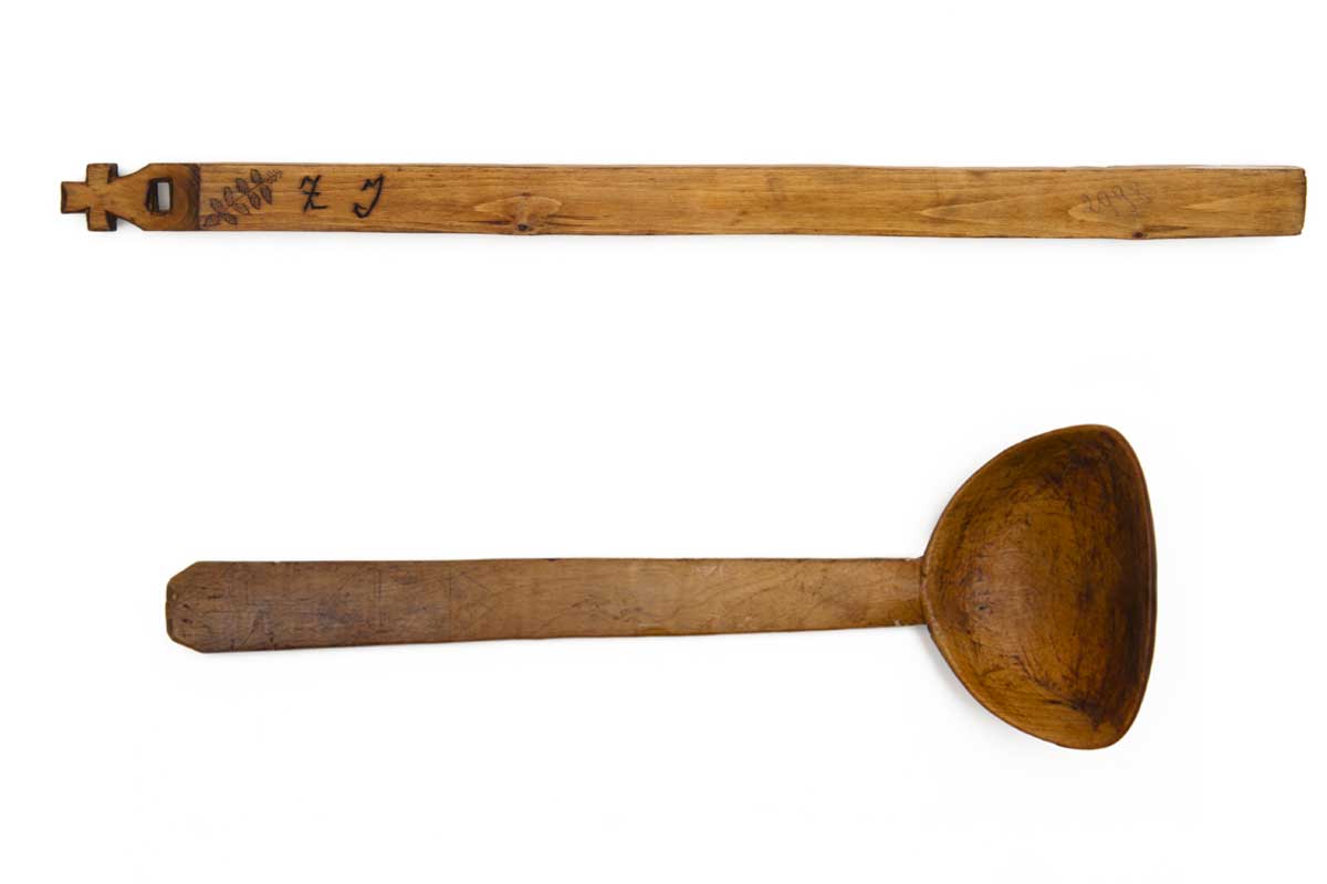 Image shows a wooden tally or measuring stick and a wooden creaming spoon