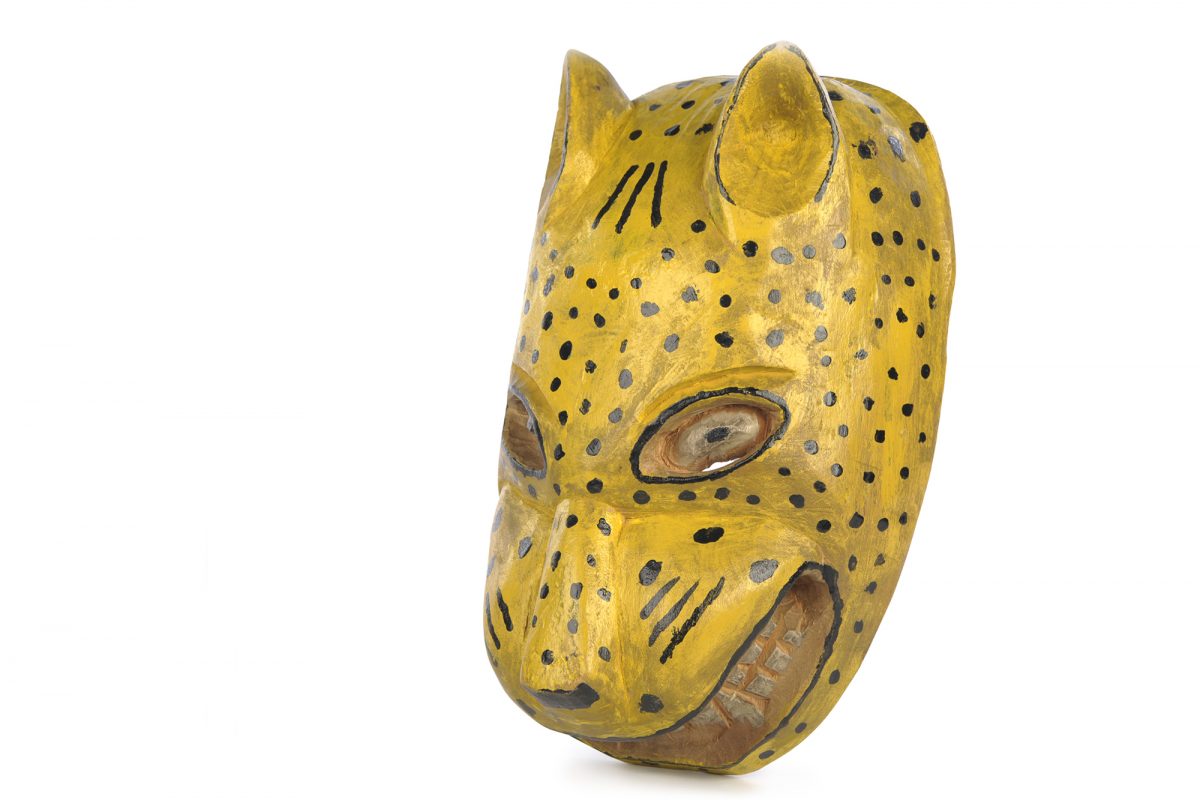 Yellow mask shaped like the head of a tiger