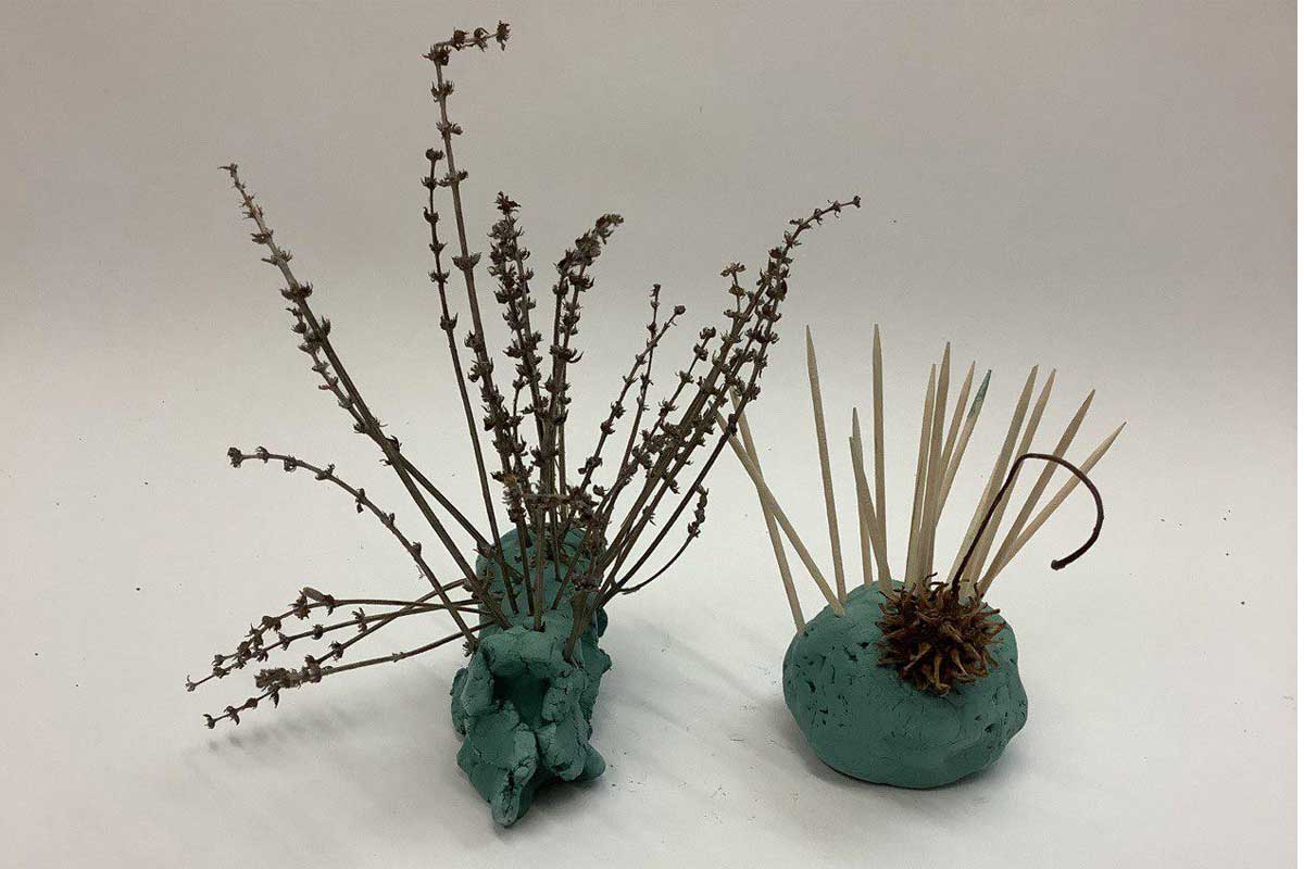 Two hedgehogs made from clay, cocktail sticks and plants