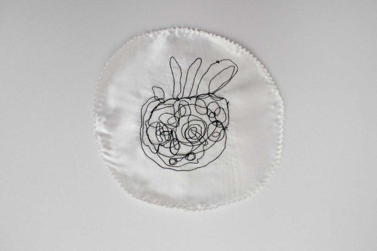 Embroidery of a drawing of a shell