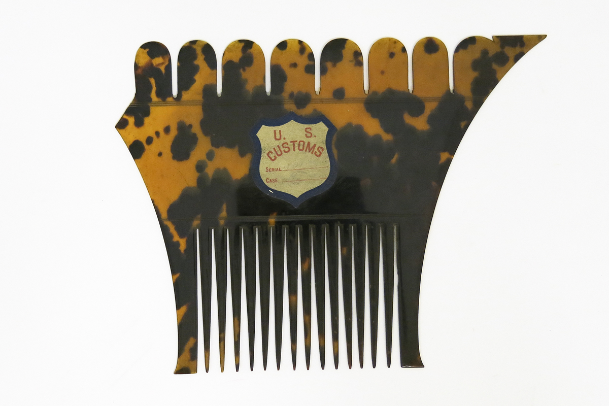Tortoiseshell comb with a label reading 'US Customs'