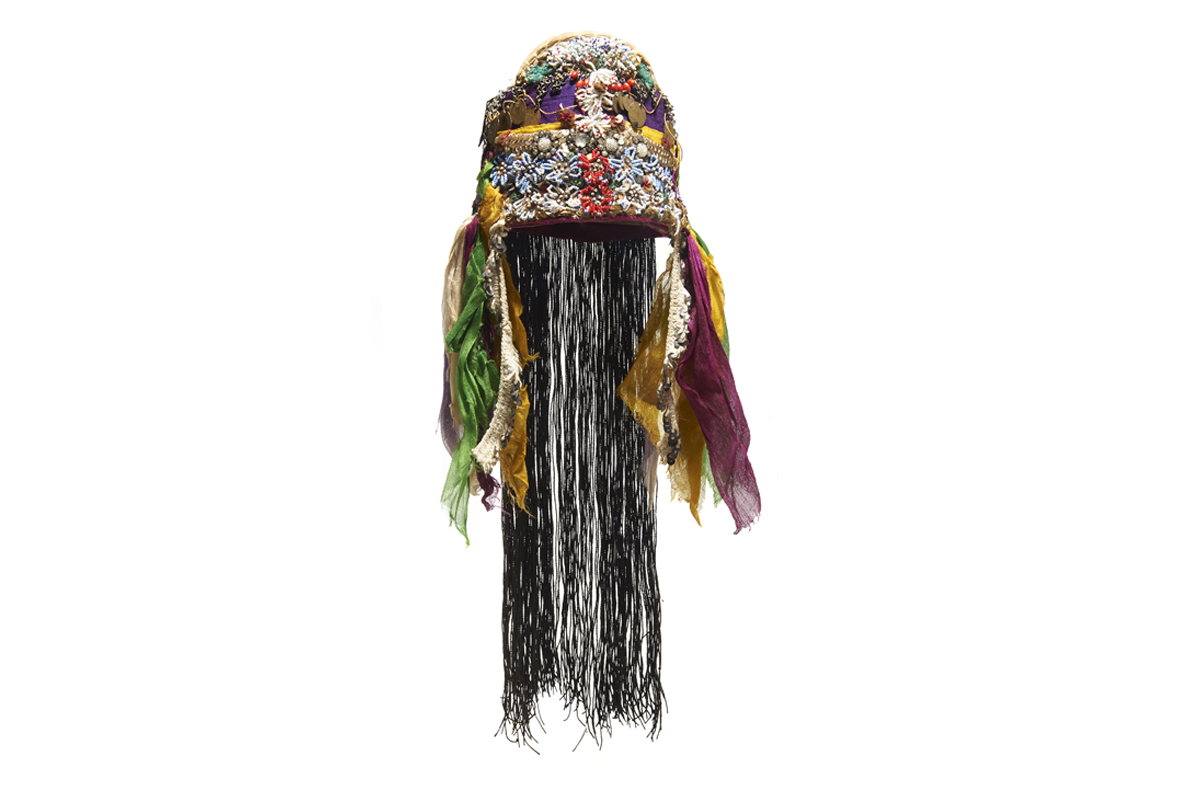 A colourful headdress with hair at the back