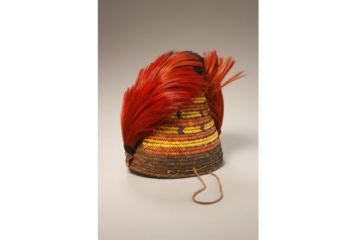 A red, yellow and brown helmet with two side pieces which look like feathers