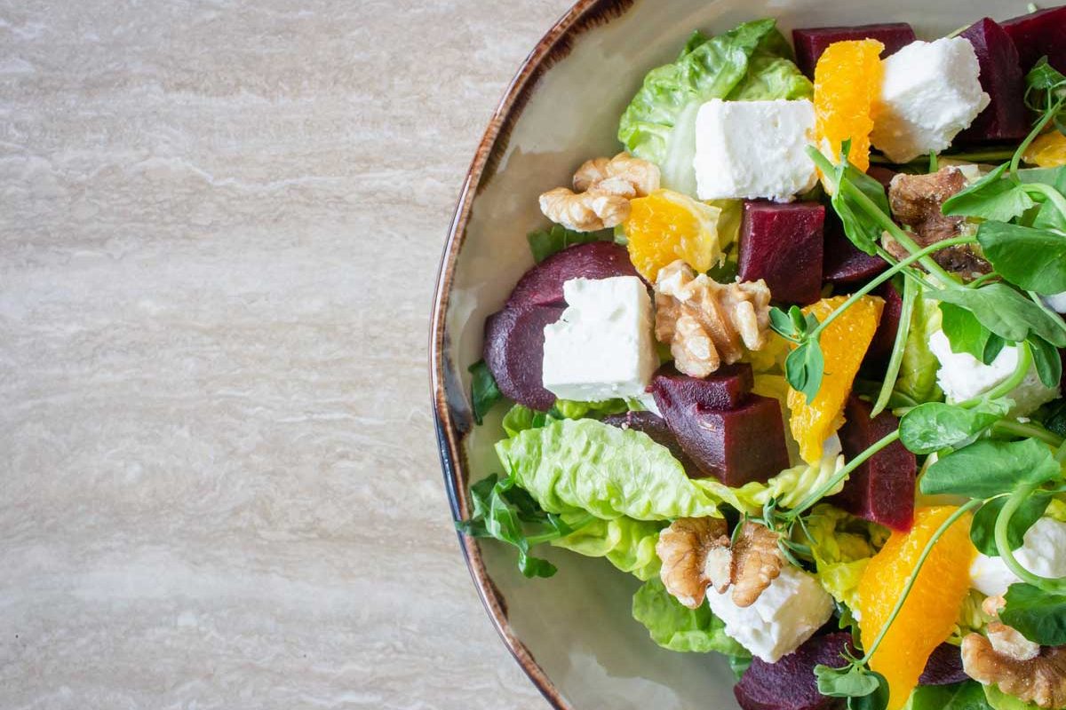 A colourful bowl of salad with feta, walnuts and beetroot