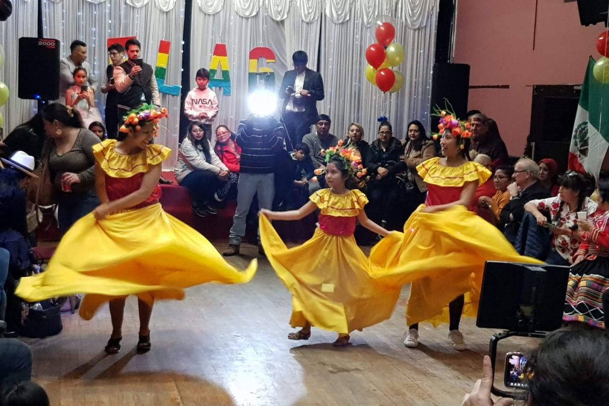 Latin American dancers in yellow dresses