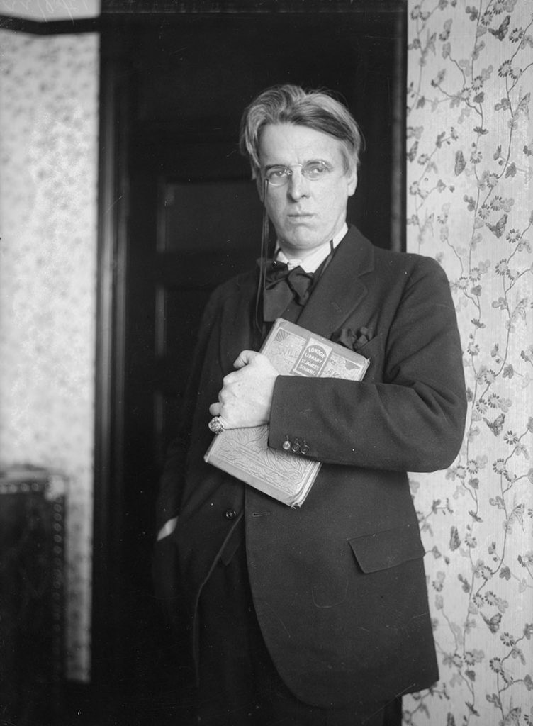 A photo of W B Yeats holding a book