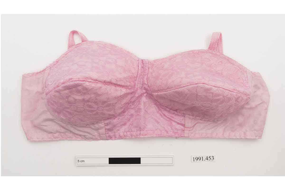 Pink non underwired bra with darted cups and a floral lacework pattern overall.