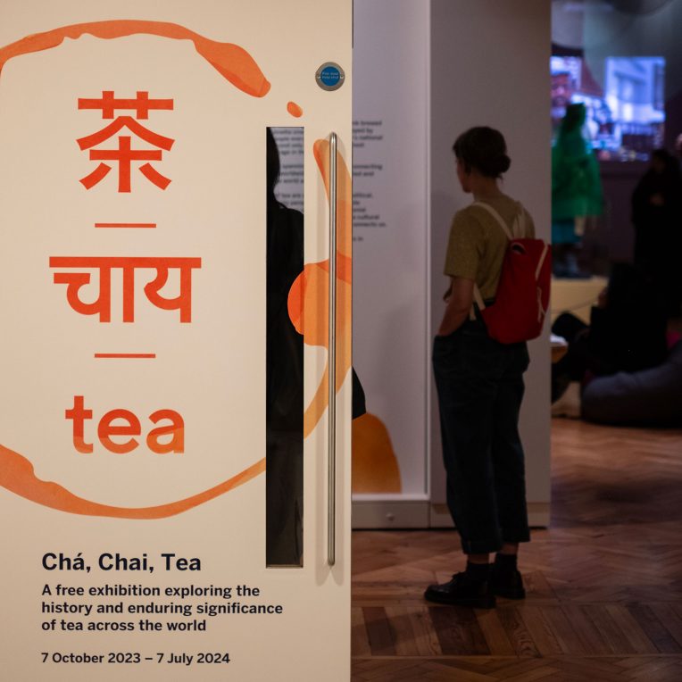 A woman stands just inside the Cha, Chai, Tea exhibition
