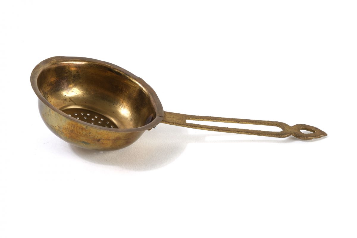 A metal tea strainer