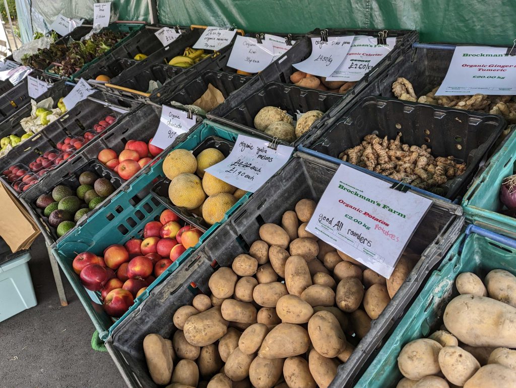 Boxes of different fruit and veg on market stall