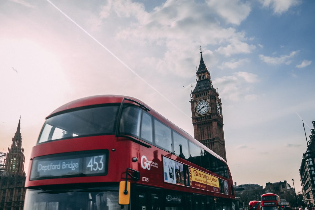 The top of a London bus with Big Ben and clear sky behind