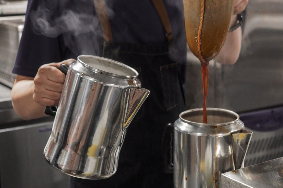 Tea being drained into a chrome kettle