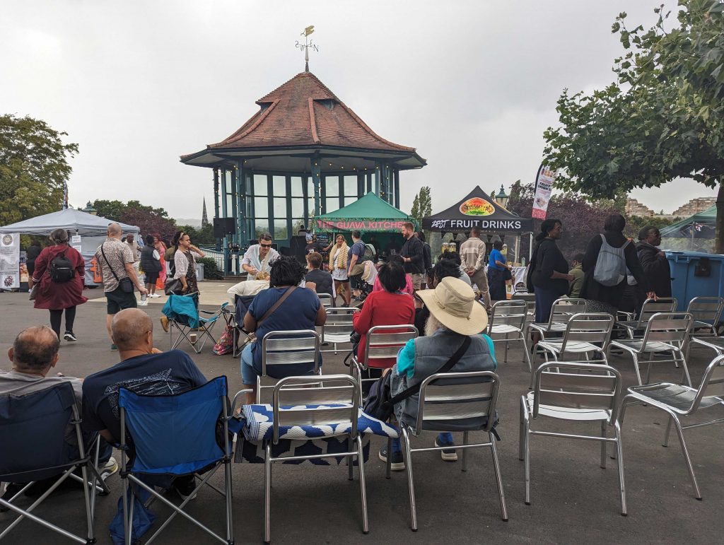 People sat on chairs in front of the Bandstand Terrace